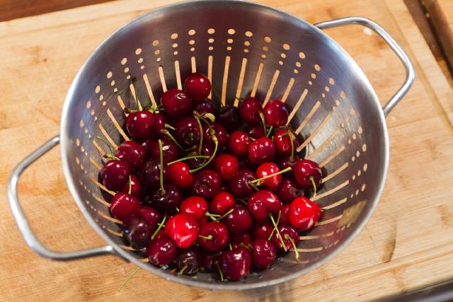 colander full of fresh cherries