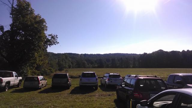 Cars parked in open field