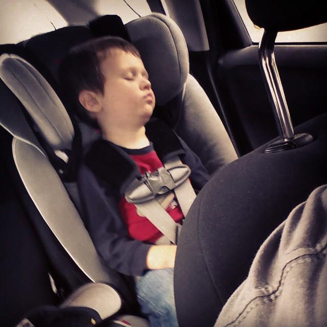 Boy asleep in a car seat