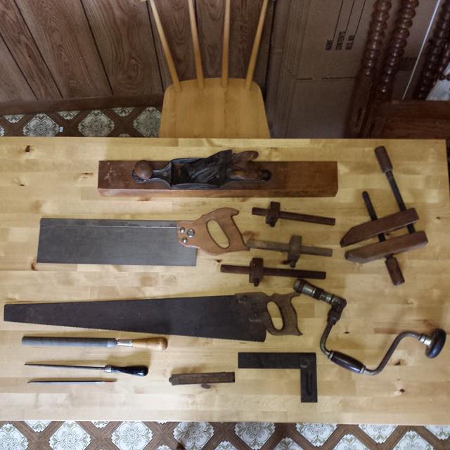 antique tools arrayed on a wooden table