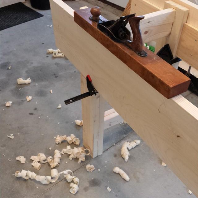 hand plane on bench with shavings below