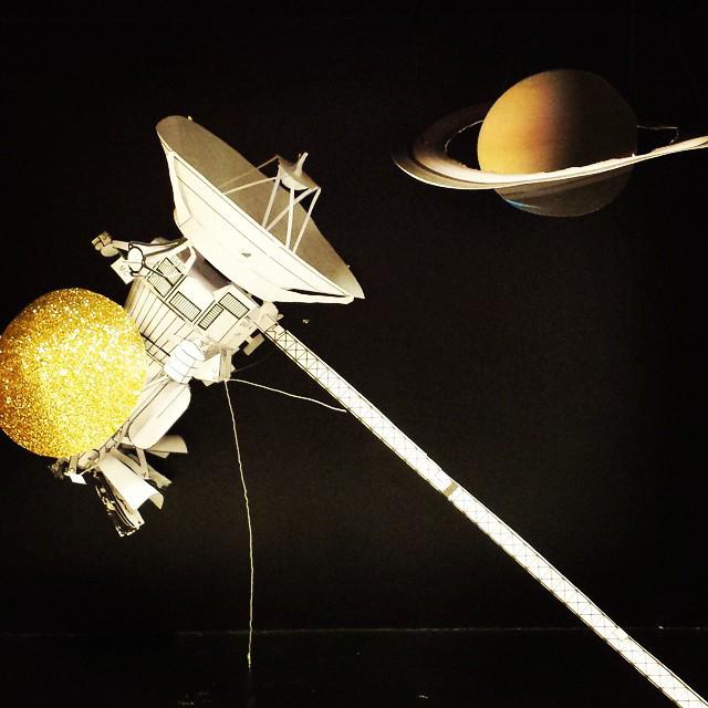 papercraft cassini/hugens probe and saturn on a black background