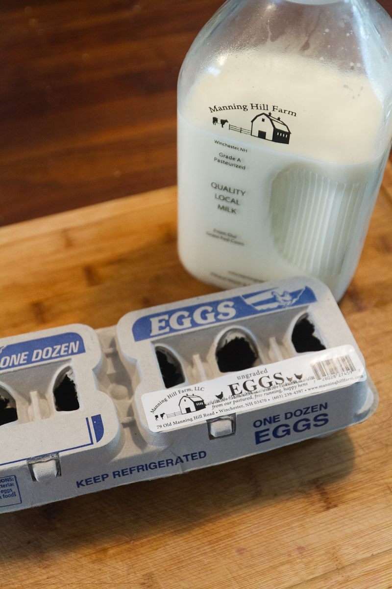glass bottle of milk and carton of eggs
